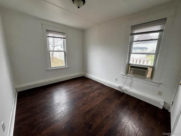 a view of wooden floor and windows in a room
