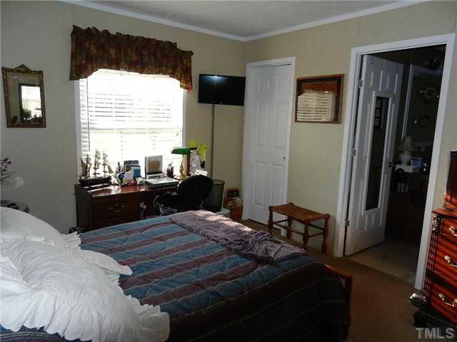 1184 Sykes Road Spring Hope, NC 27882 - Photo 12 of 12 a bedroom with a bed and a large window