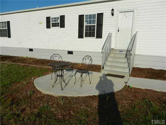 1184 Sykes Road Spring Hope, NC 27882 - Photo 3 of 12 a view of entryway dining room and hall with wooden floor