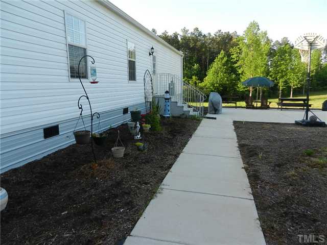 1184 Sykes Road Spring Hope, NC 27882 - Photo 5 of 12 a view of a backyard with sitting area