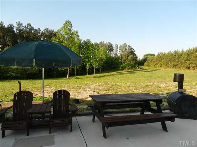 1184 Sykes Road Spring Hope, NC 27882 - Photo 8 of 12 a view of a swimming pool with lounge chairs