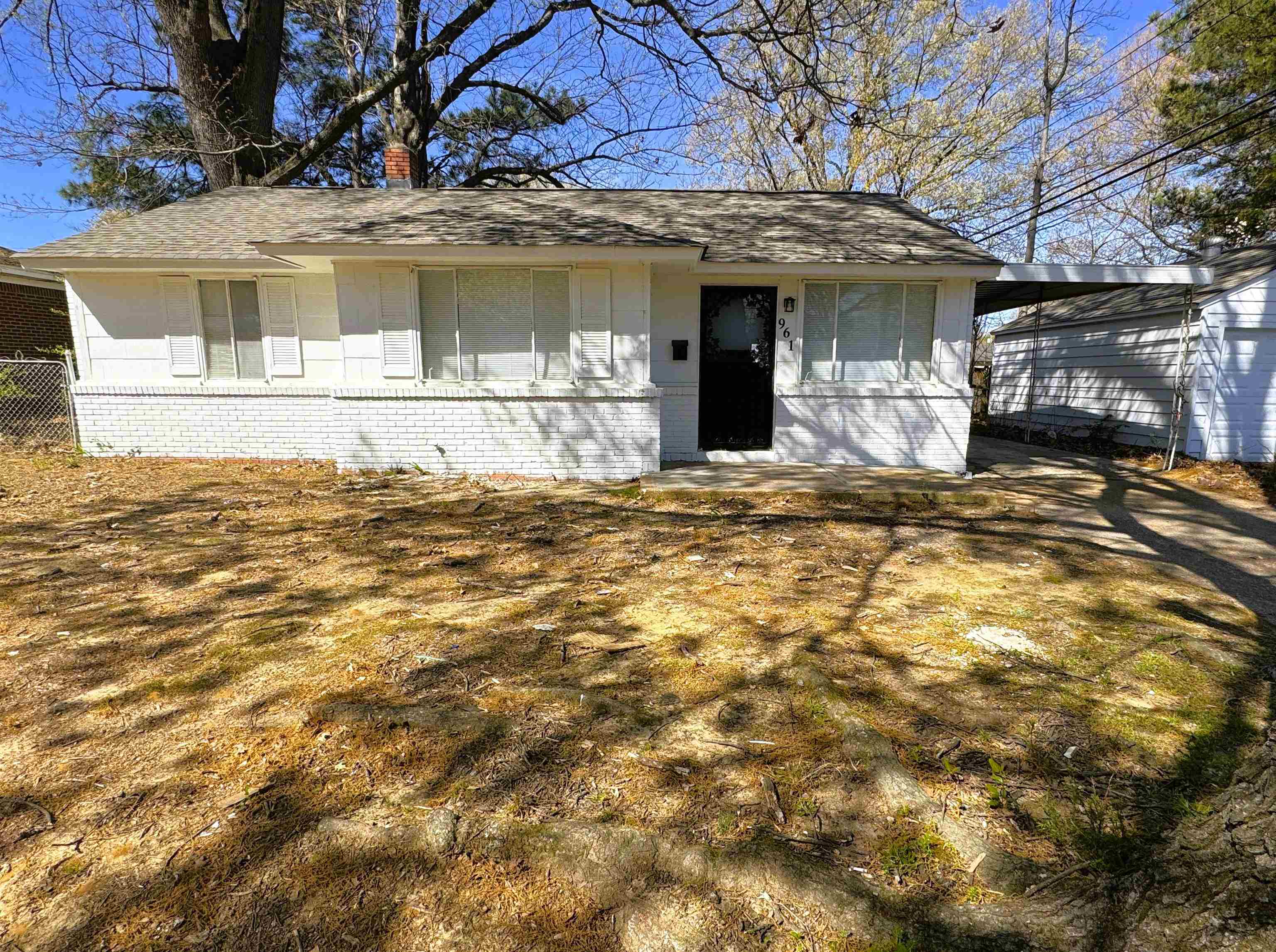 961 North Perkins Road Memphis, TN 38122 - Photo 1 of 15 View of front of house with an attached carport, a chimney, roof with shingles, and brick siding