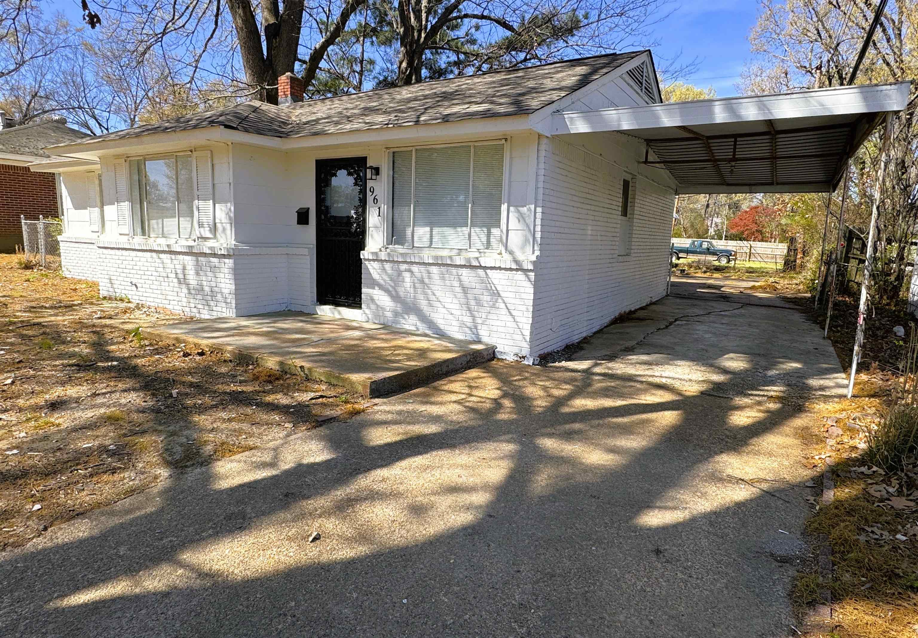 961 North Perkins Road Memphis, TN 38122 - Photo 13 of 15 View of front of home featuring a carport, brick siding, driveway, and a chimney