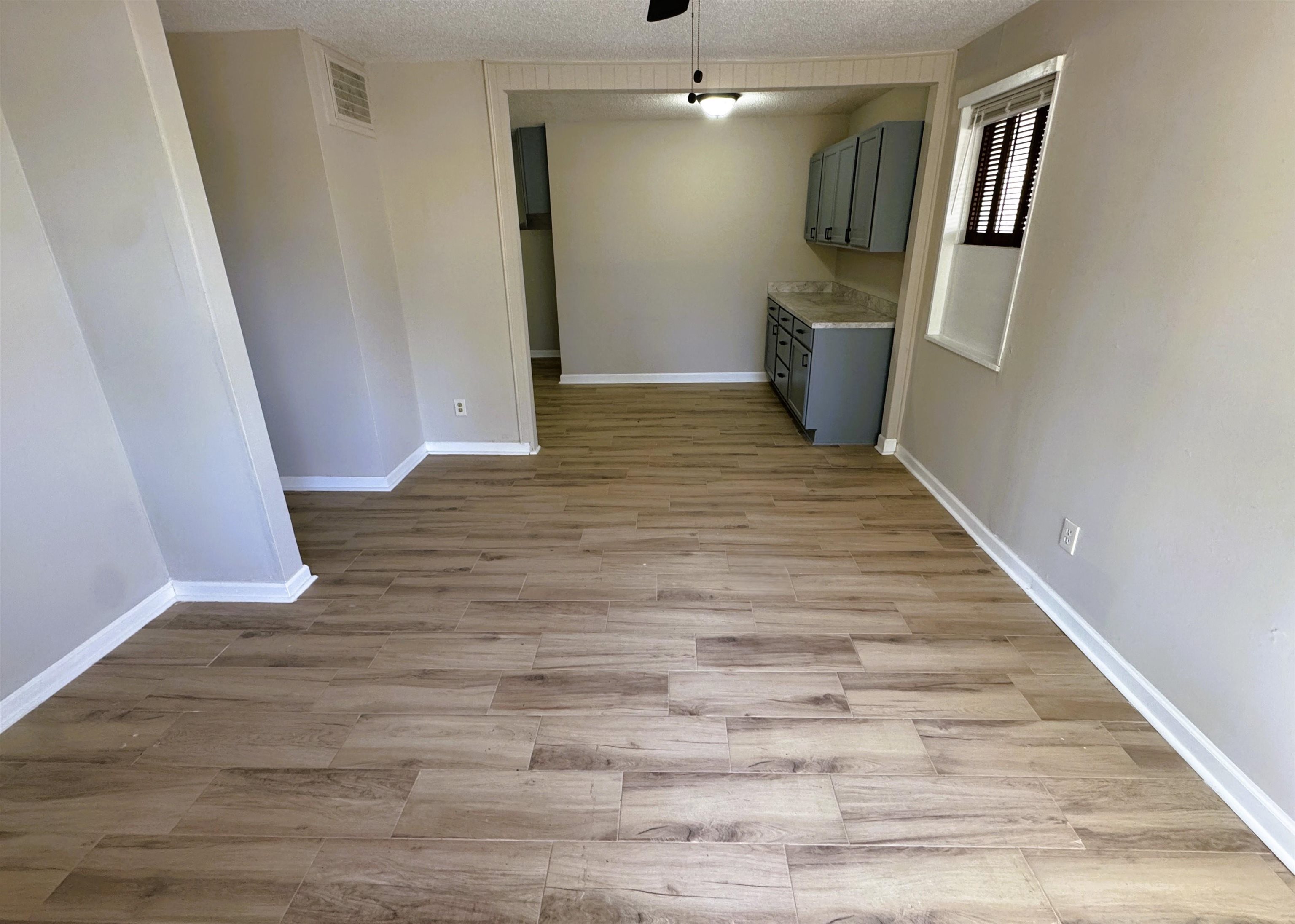 961 North Perkins Road Memphis, TN 38122 - Photo 2 of 15 Unfurnished dining area featuring a textured ceiling, light wood-style floors, and a ceiling fan