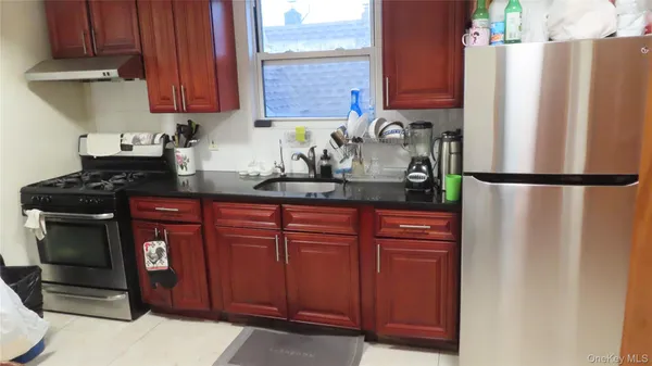 a kitchen with stainless steel appliances granite countertop a refrigerator and a stove