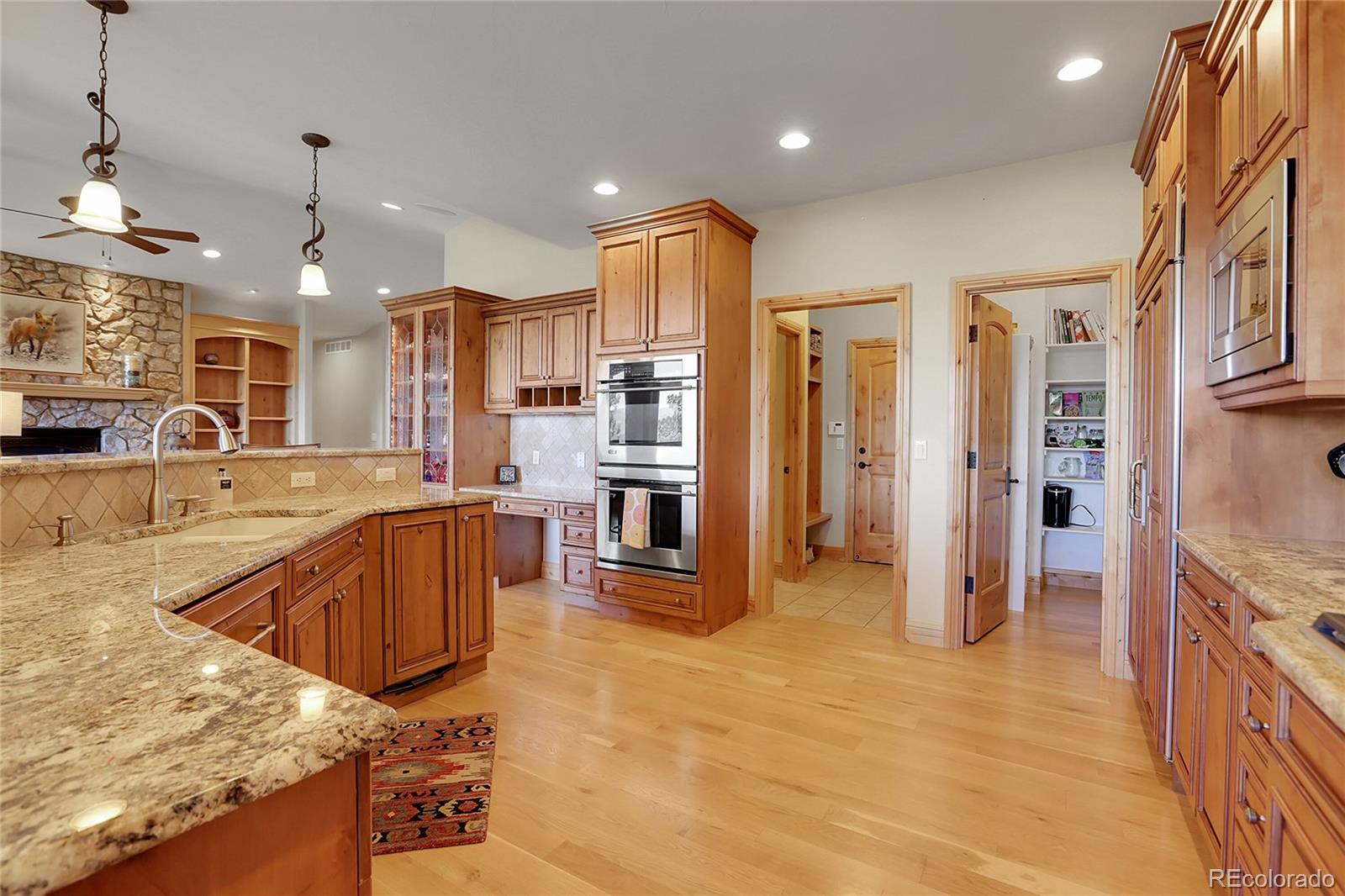 1007 Nob Hill Road Evergreen, CO 80439 - Photo 12 of 48 a kitchen with stainless steel appliances granite countertop a refrigerator a oven and a sink with large countertops
