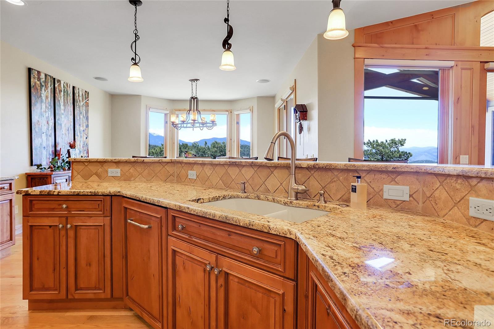 1007 Nob Hill Road Evergreen, CO 80439 - Photo 14 of 48 a bathroom with a granite countertop sink and a mirror