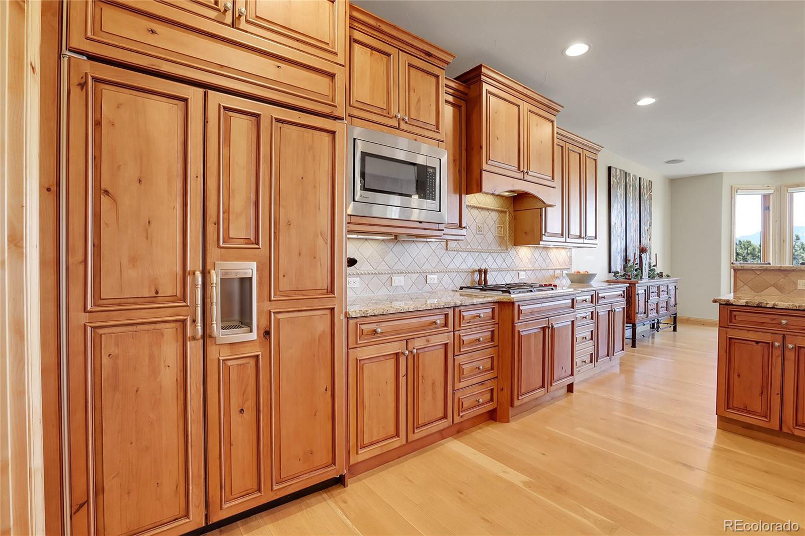 1007 Nob Hill Road Evergreen, CO 80439 - Photo 15 of 48 a kitchen with stainless steel appliances granite countertop a refrigerator and cabinets