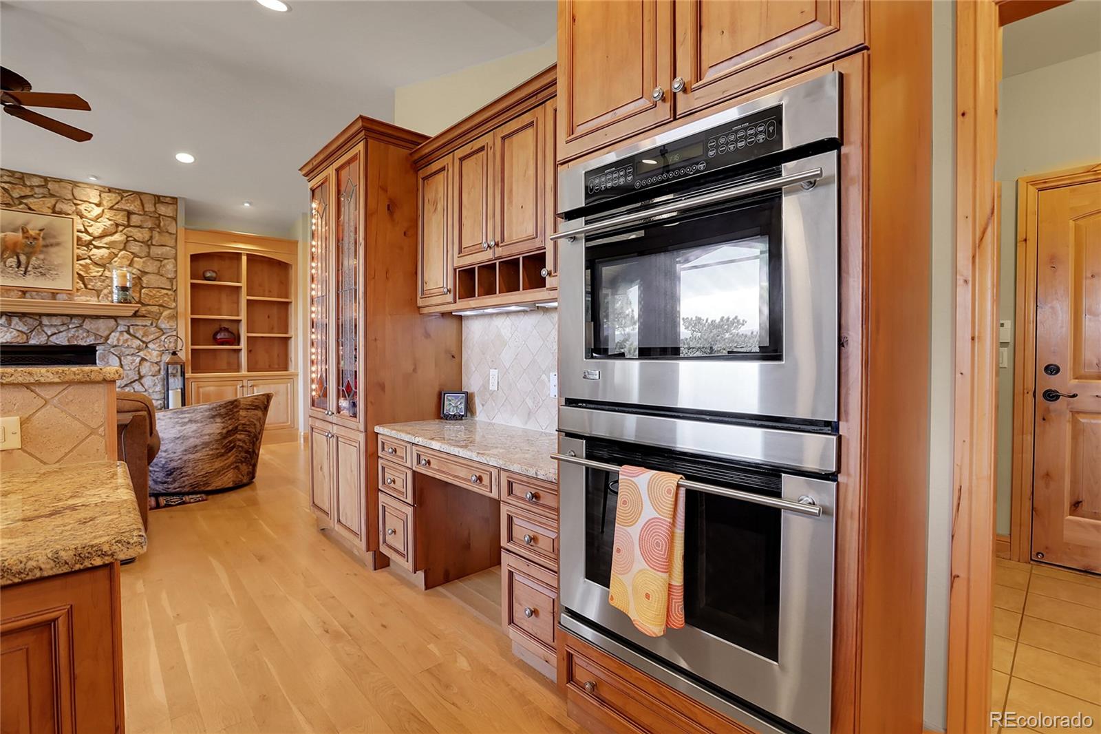 1007 Nob Hill Road Evergreen, CO 80439 - Photo 16 of 48 a kitchen with granite countertop a stove and a refrigerator