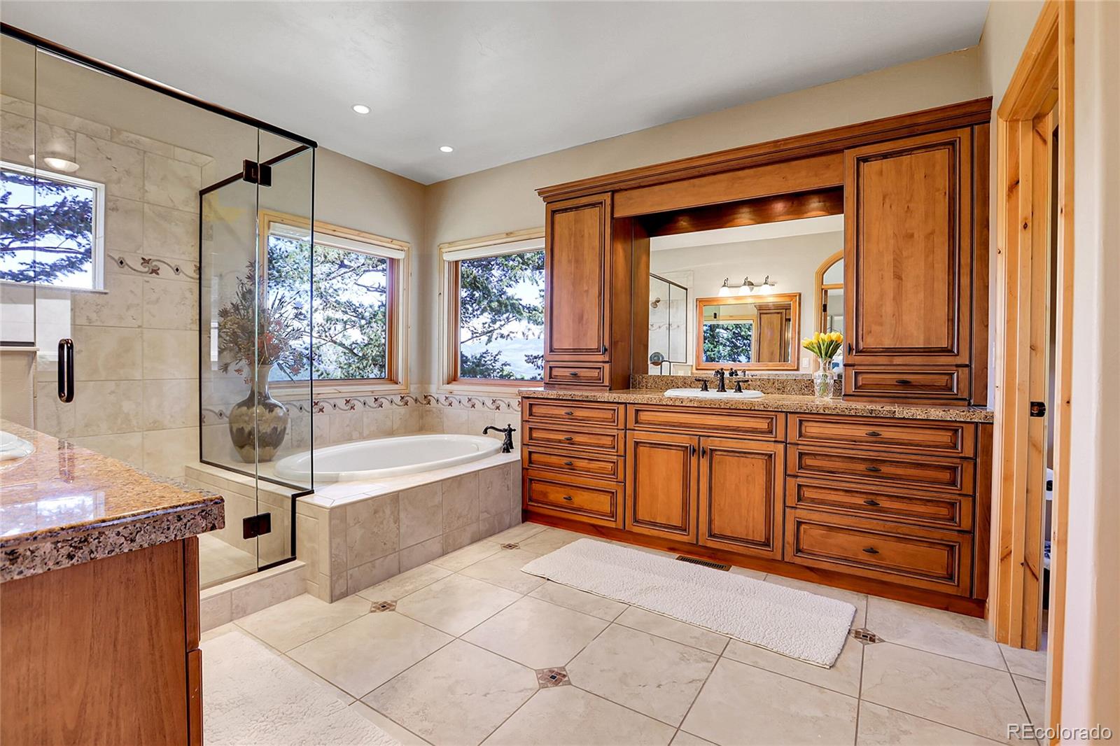 1007 Nob Hill Road Evergreen, CO 80439 - Photo 23 of 48 a spacious bathroom with a vanity a bathtub and a sink