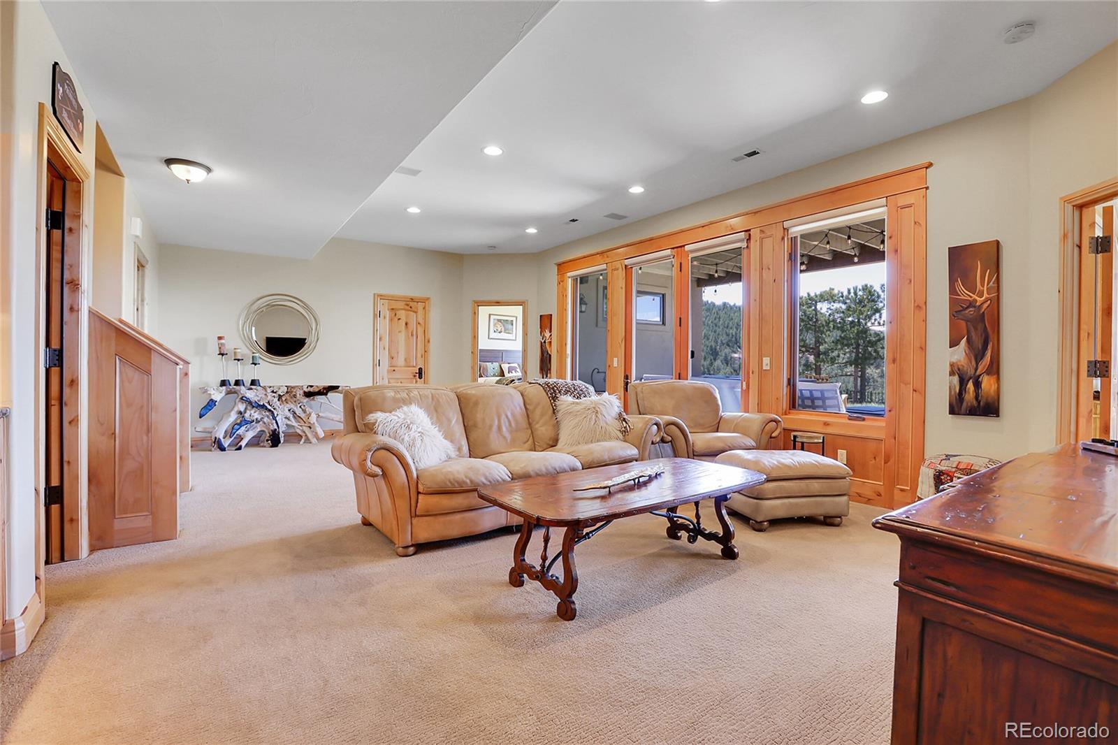 1007 Nob Hill Road Evergreen, CO 80439 - Photo 31 of 48 a living room with furniture and large windows