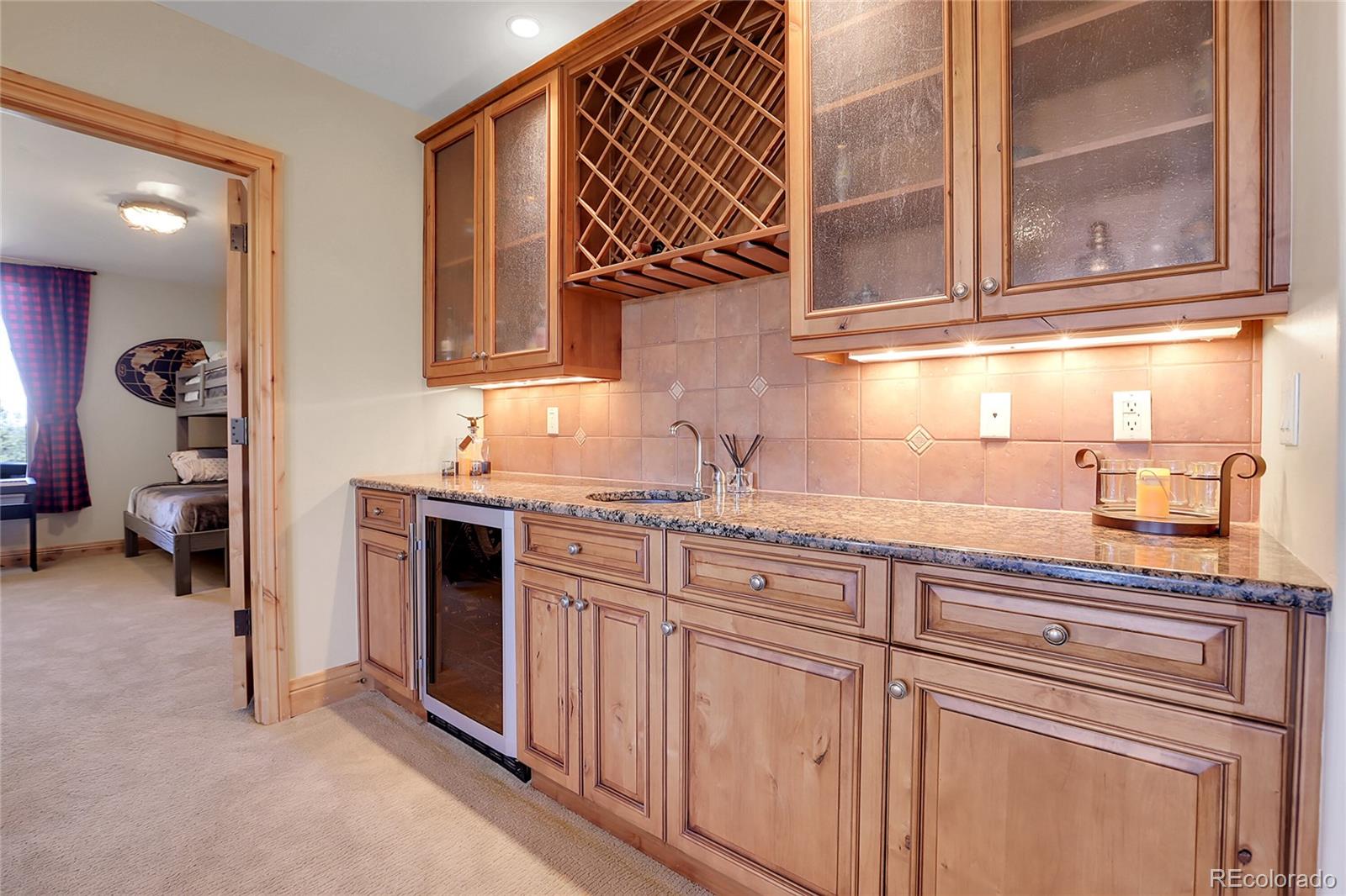 1007 Nob Hill Road Evergreen, CO 80439 - Photo 32 of 48 a kitchen with stainless steel appliances granite countertop a sink and cabinets