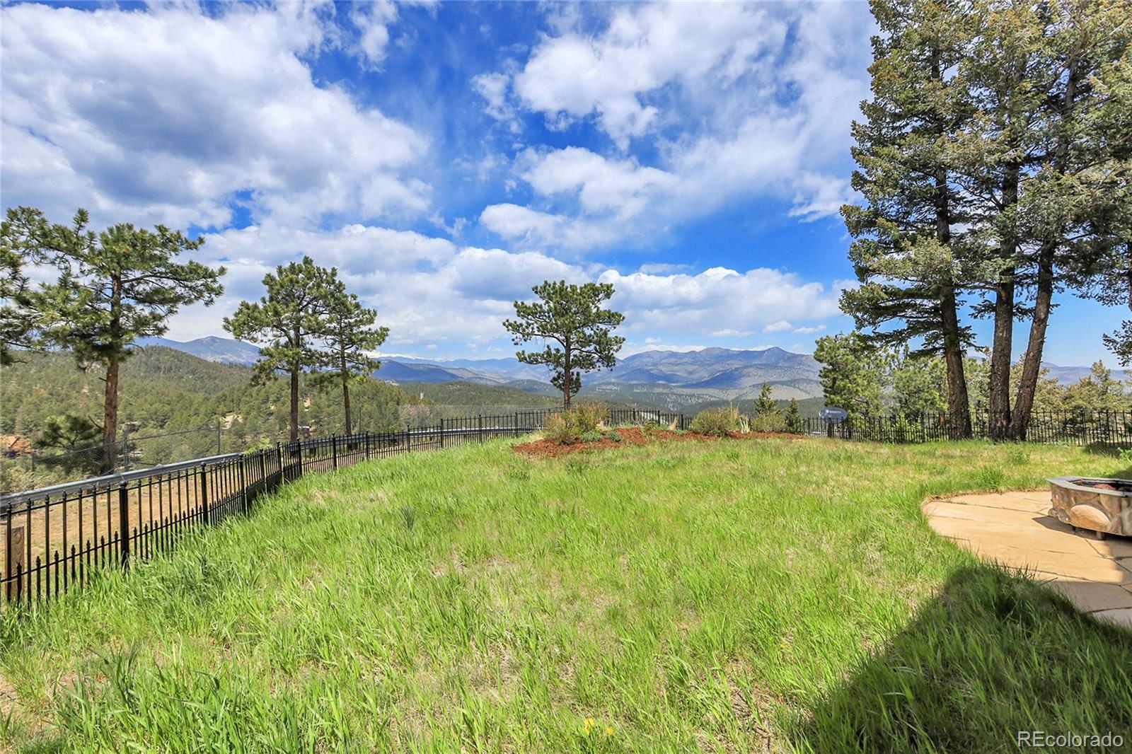 1007 Nob Hill Road Evergreen, CO 80439 - Photo 36 of 48 a view of a garden with a building