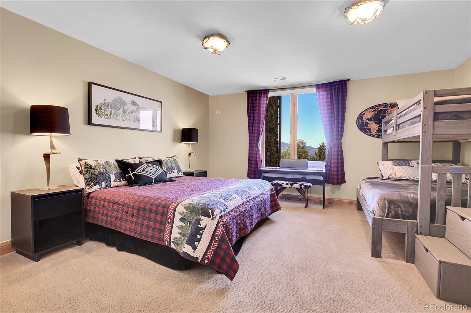 1007 Nob Hill Road Evergreen, CO 80439 - Photo 42 of 48 a spacious bedroom with a bed and window