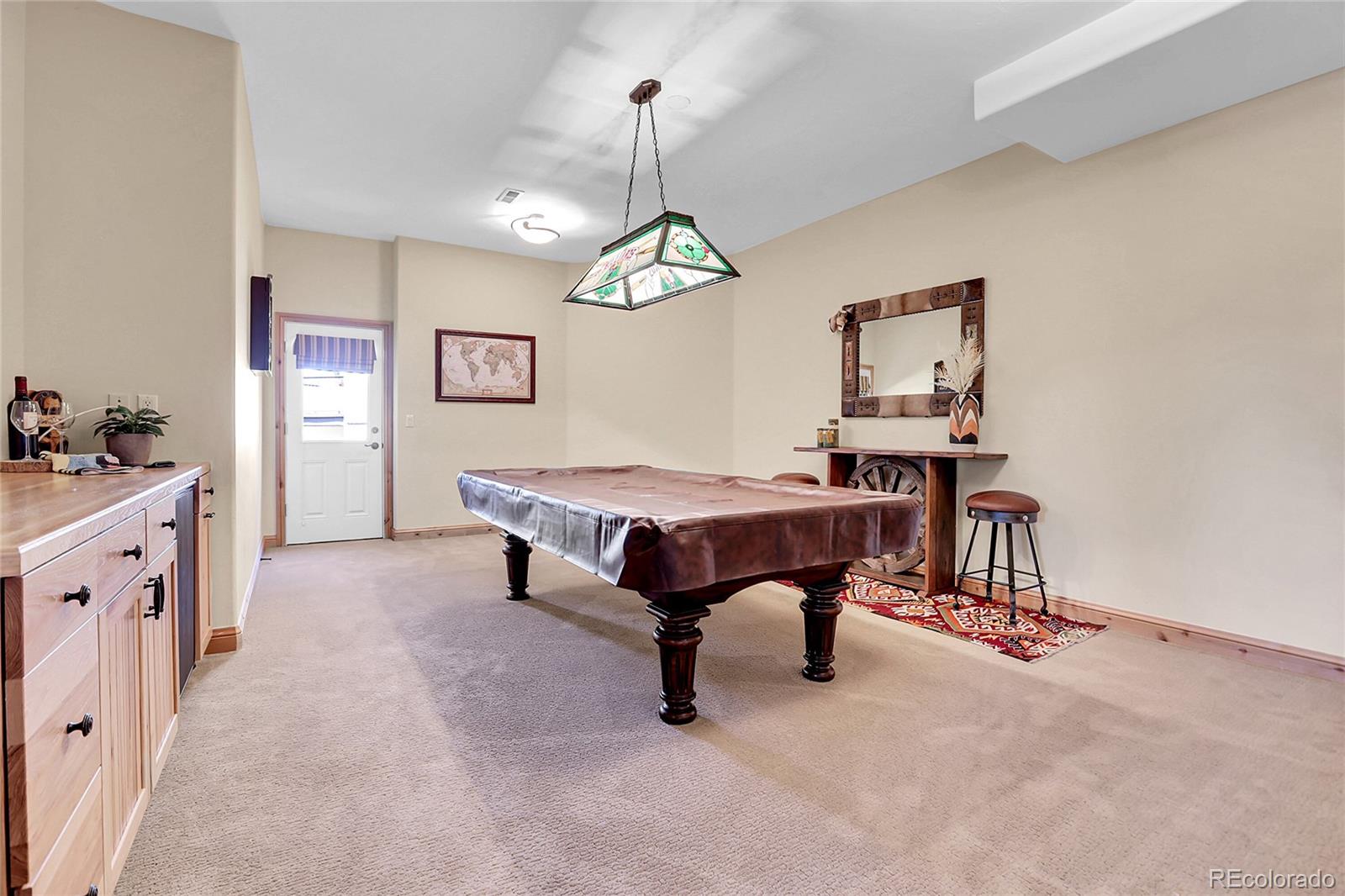 1007 Nob Hill Road Evergreen, CO 80439 - Photo 43 of 48 a living room with furniture and a table