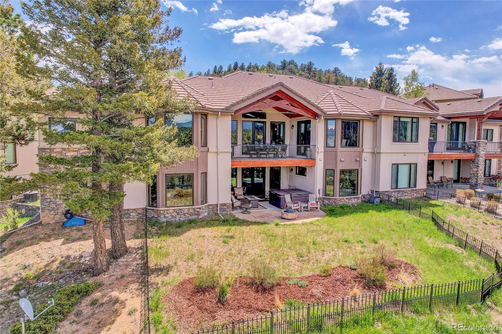 1007 Nob Hill Road Evergreen, CO 80439 - Photo 45 of 48 a view of a large with large pool and couches chairs