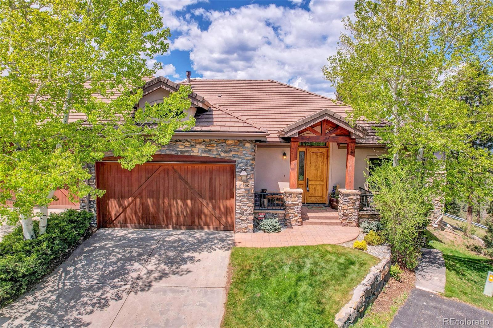 1007 Nob Hill Road Evergreen, CO 80439 - Photo 47 of 48 a front view of a house with garden