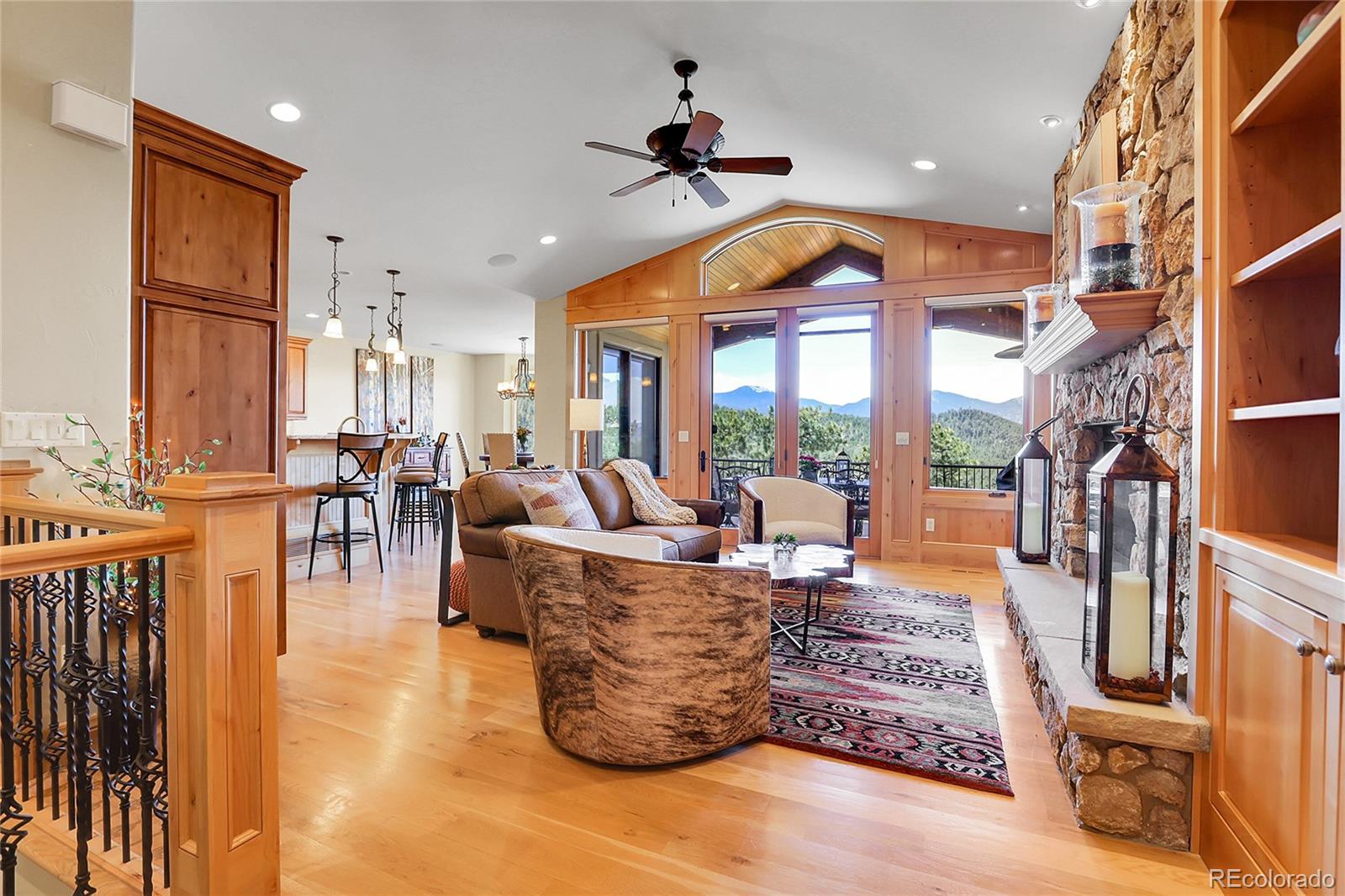 1007 Nob Hill Road Evergreen, CO 80439 - Photo 5 of 48 a living room with fireplace furniture and a large window