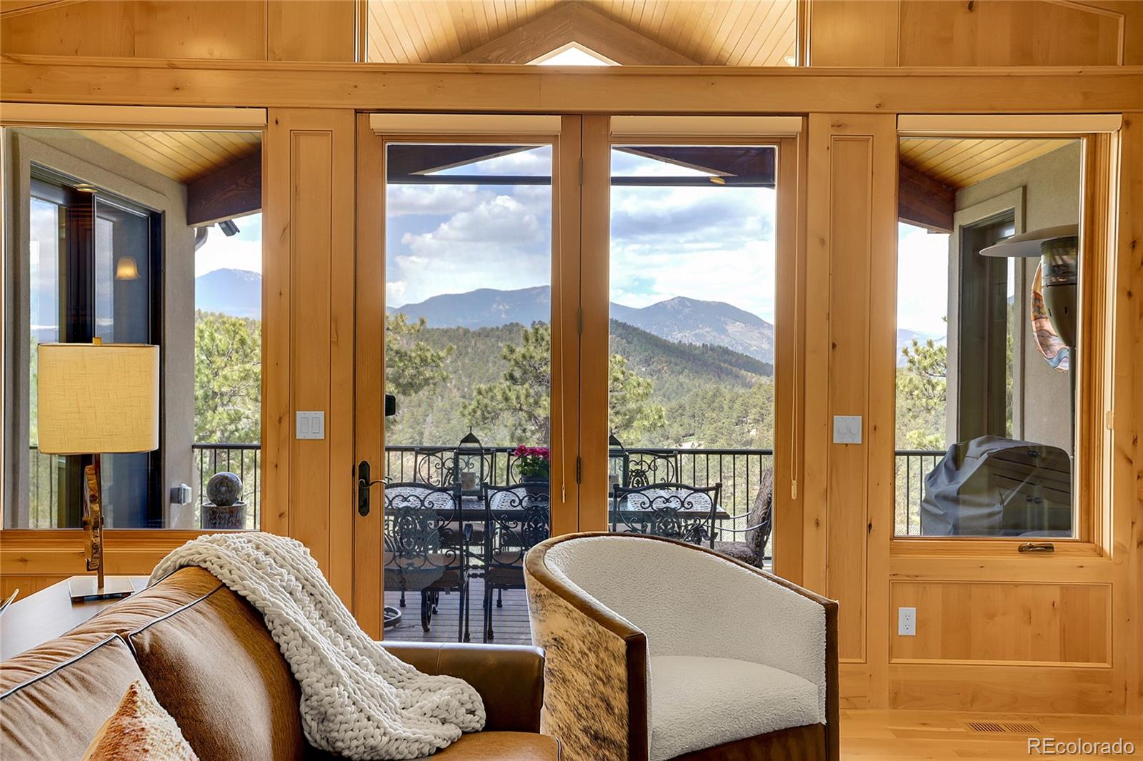 1007 Nob Hill Road Evergreen, CO 80439 - Photo 6 of 48 a living room with furniture and a large window