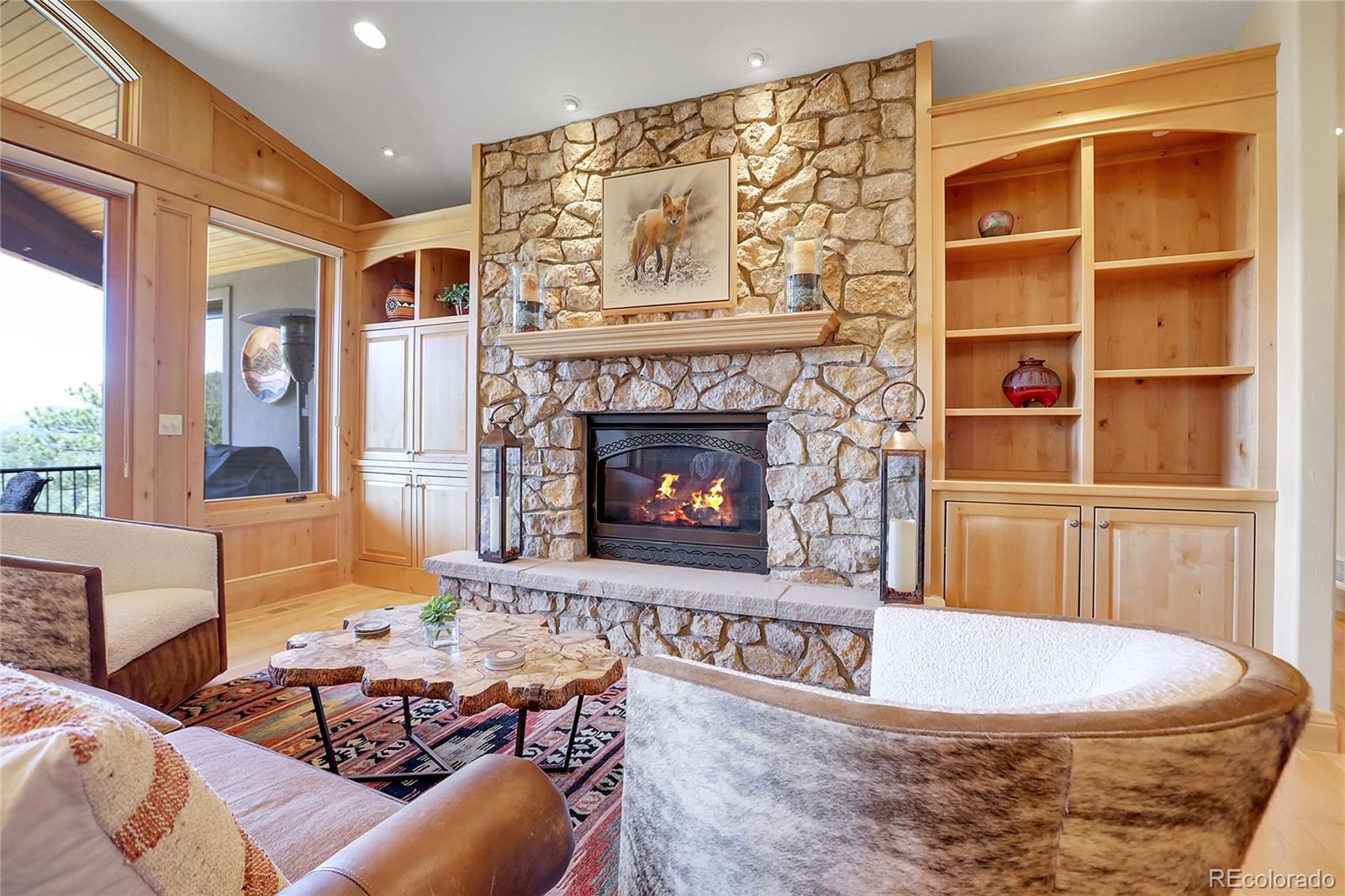 1007 Nob Hill Road Evergreen, CO 80439 - Photo 7 of 48 a living room with furniture and a fireplace