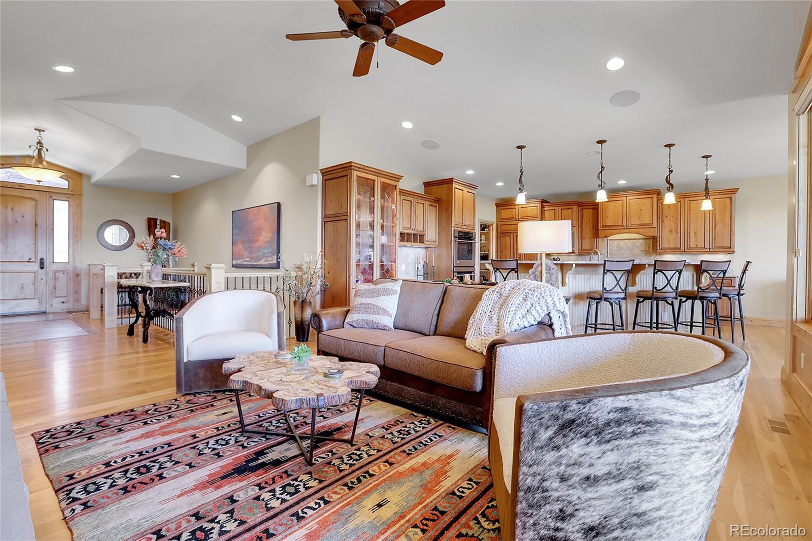 1007 Nob Hill Road Evergreen, CO 80439 - Photo 9 of 48 a living room with furniture and a chandelier
