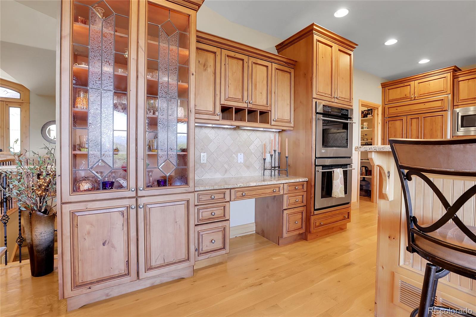 1007 Nob Hill Road Evergreen, CO 80439 - Photo 10 of 48 a kitchen with stainless steel appliances granite countertop a stove and cabinets