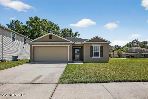 a front view of a house with a yard and garage