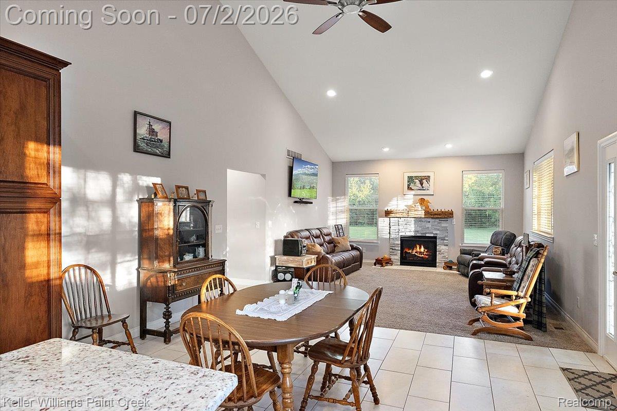 54230 Card Road Macomb, MI 48042 - Photo 35 of 73 Open-concept living space featuring vaulted ceilings, recessed lighting, and a stone-surround fireplace