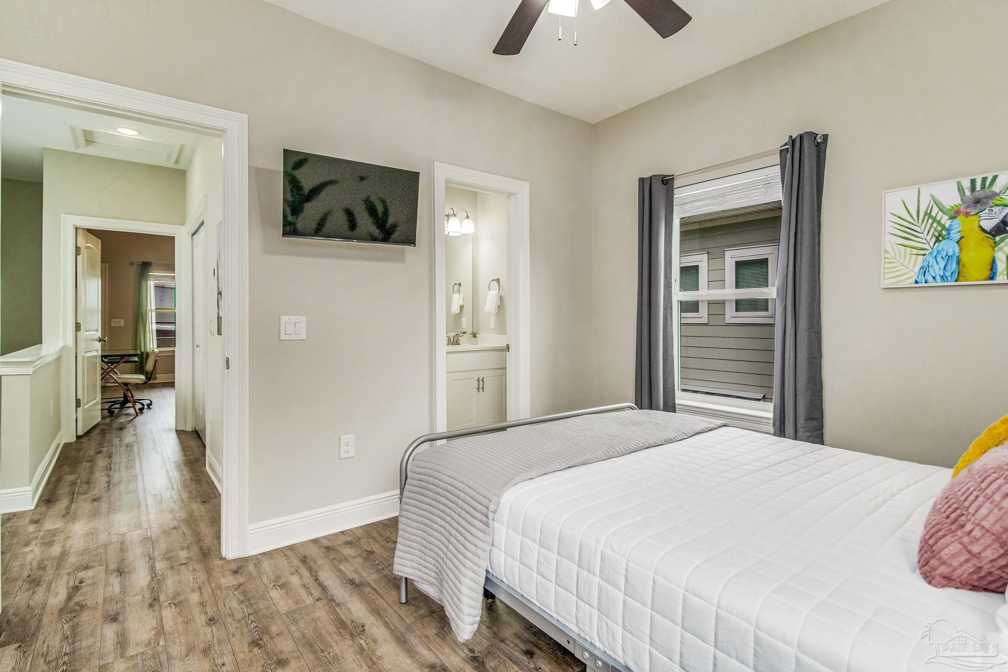 1002 West Main Street Pensacola, FL 32502 - Photo 11 of 32 a bedroom with a bed and a chandelier