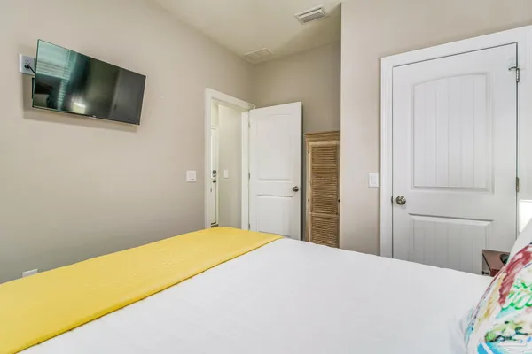 a bedroom with a bed and a flat screen tv