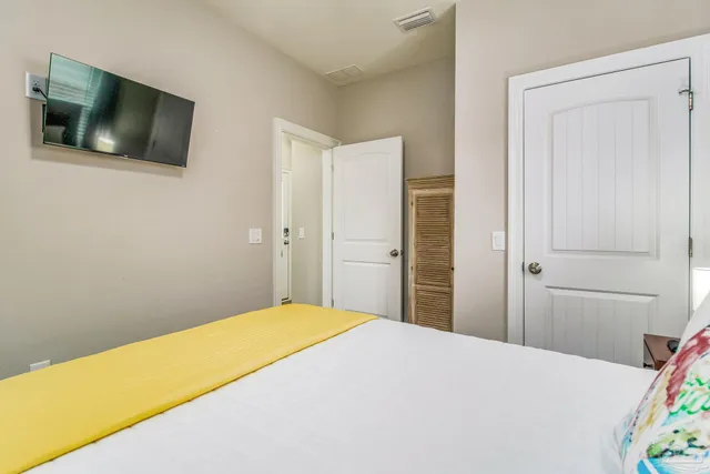 a bedroom with a bed and a flat screen tv