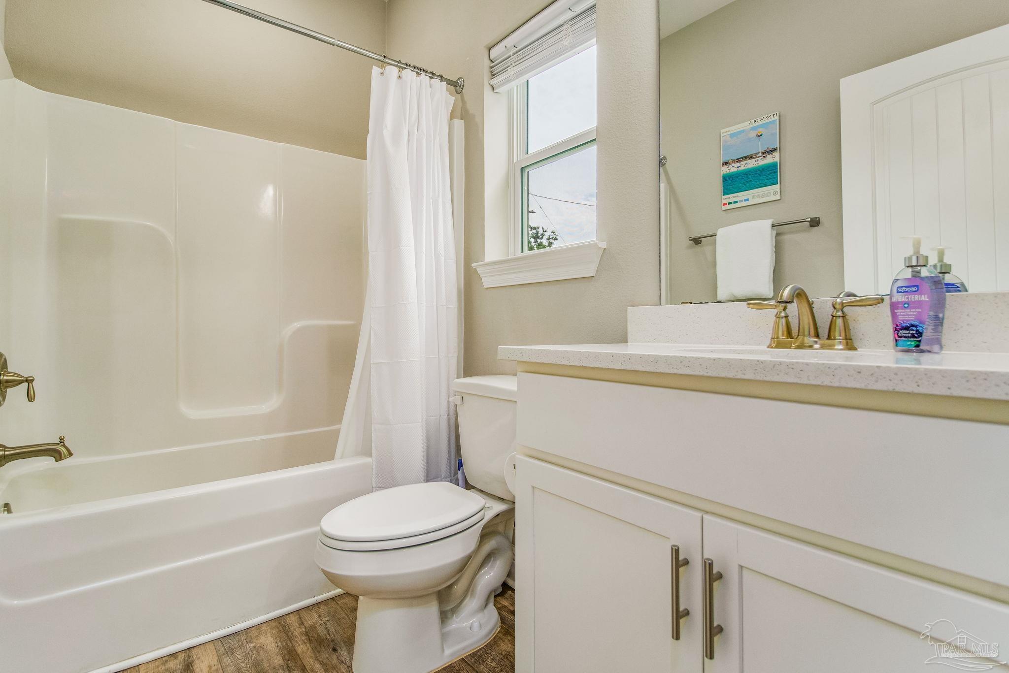 1002 West Main Street Pensacola, FL 32502 - Photo 16 of 32 a bathroom with a sink toilet vanity and shower
