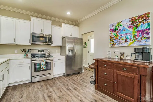 a kitchen with stainless steel appliances a stove microwave and refrigerator