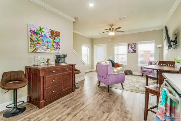 a living room with furniture and a bookshelf