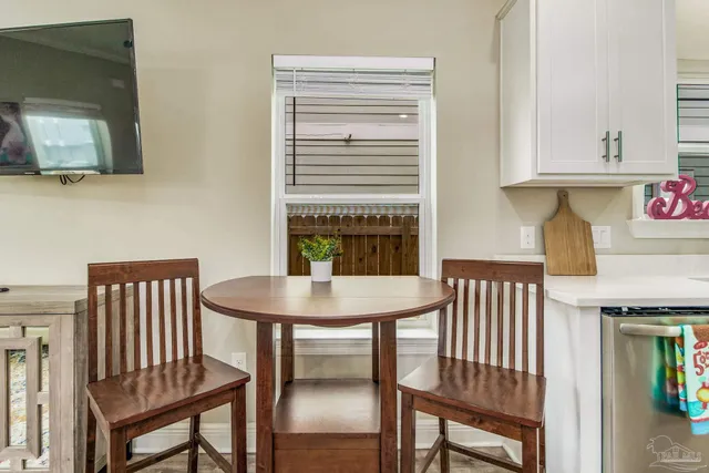 a view of a room with furniture and wooden floor