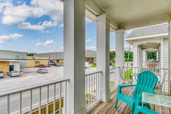 a view of balcony with two chairs and door