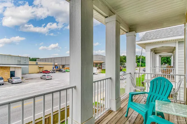 a view of balcony with two chairs and door