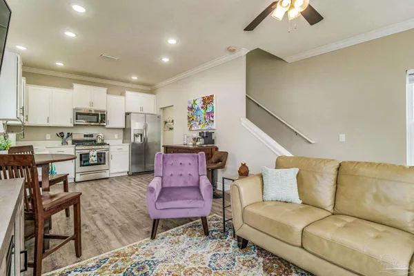 a living room with furniture and kitchen view