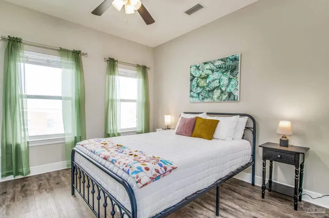 a bedroom with a bed a table and window