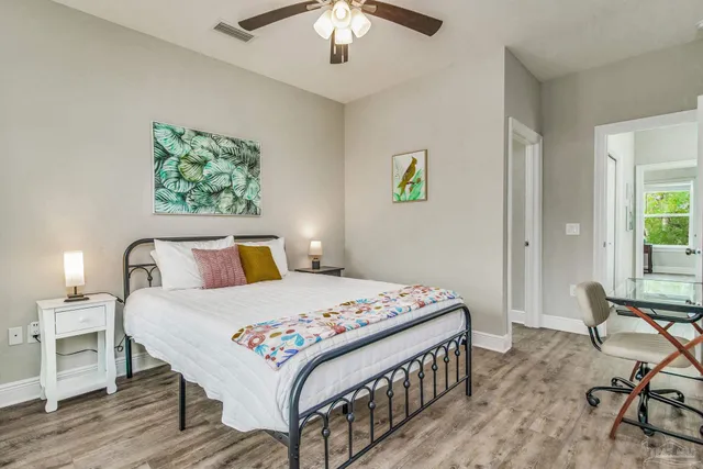 a bedroom that has a bed and a table in it