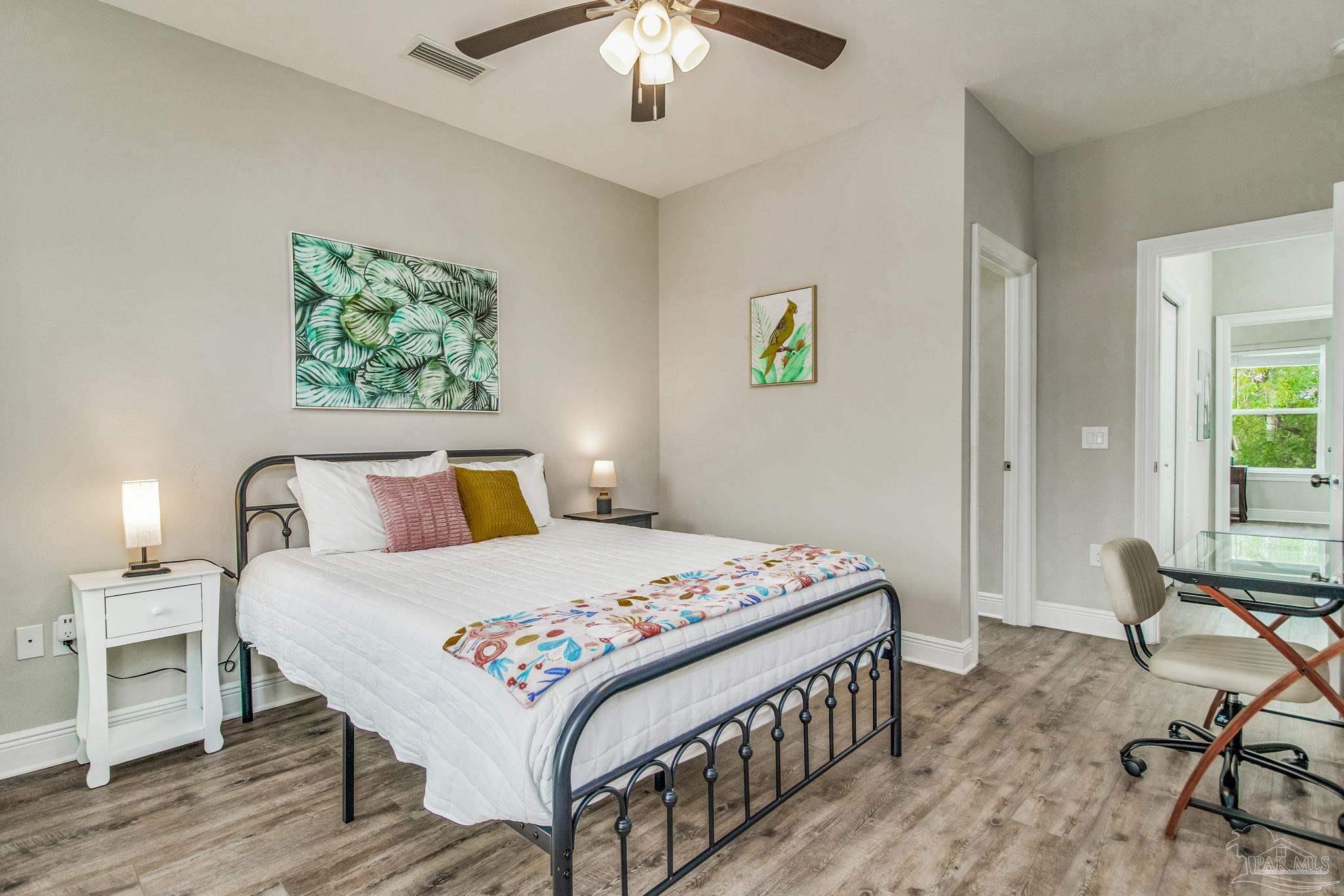 1002 West Main Street Pensacola, FL 32502 - Photo 7 of 32 a bedroom that has a bed and a table in it