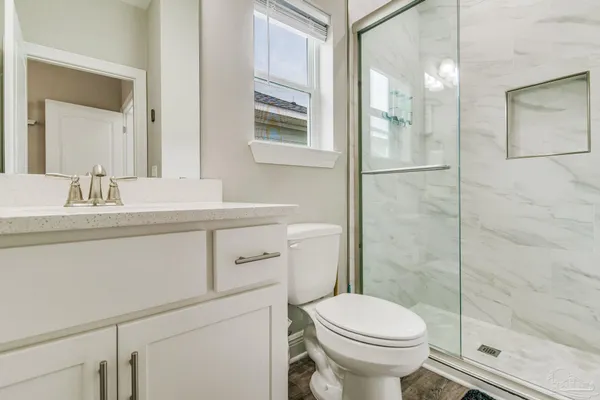 a bathroom with a sink toilet and shower