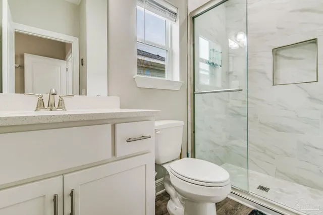 a bathroom with a sink toilet and shower