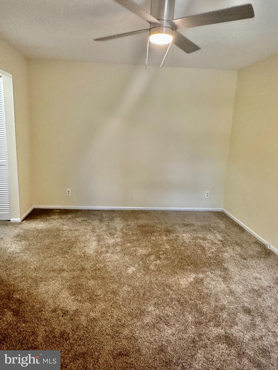 7904 Inverton Road, Unit 204 Annandale, VA 22003 - Photo 13 of 24 an empty room with a ceiling fan and carpet