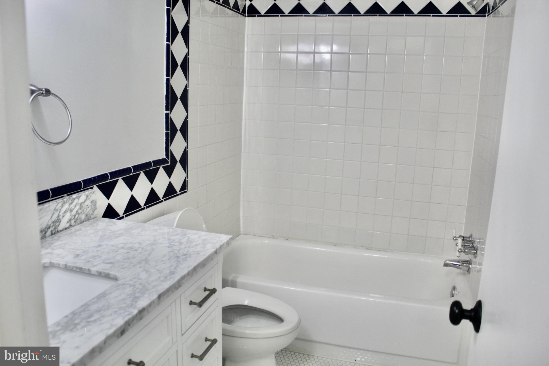 7904 Inverton Road, Unit 204 Annandale, VA 22003 - Photo 15 of 24 a bathroom with a granite countertop sink and a mirror