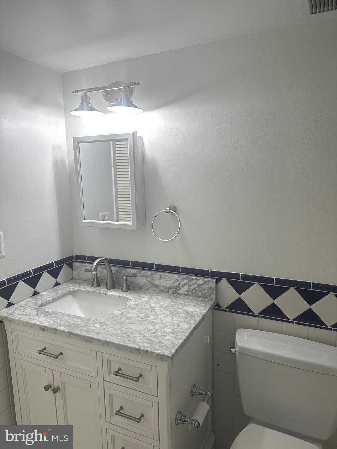 7904 Inverton Road, Unit 204 Annandale, VA 22003 - Photo 16 of 24 a bathroom with a granite countertop sink and a mirror