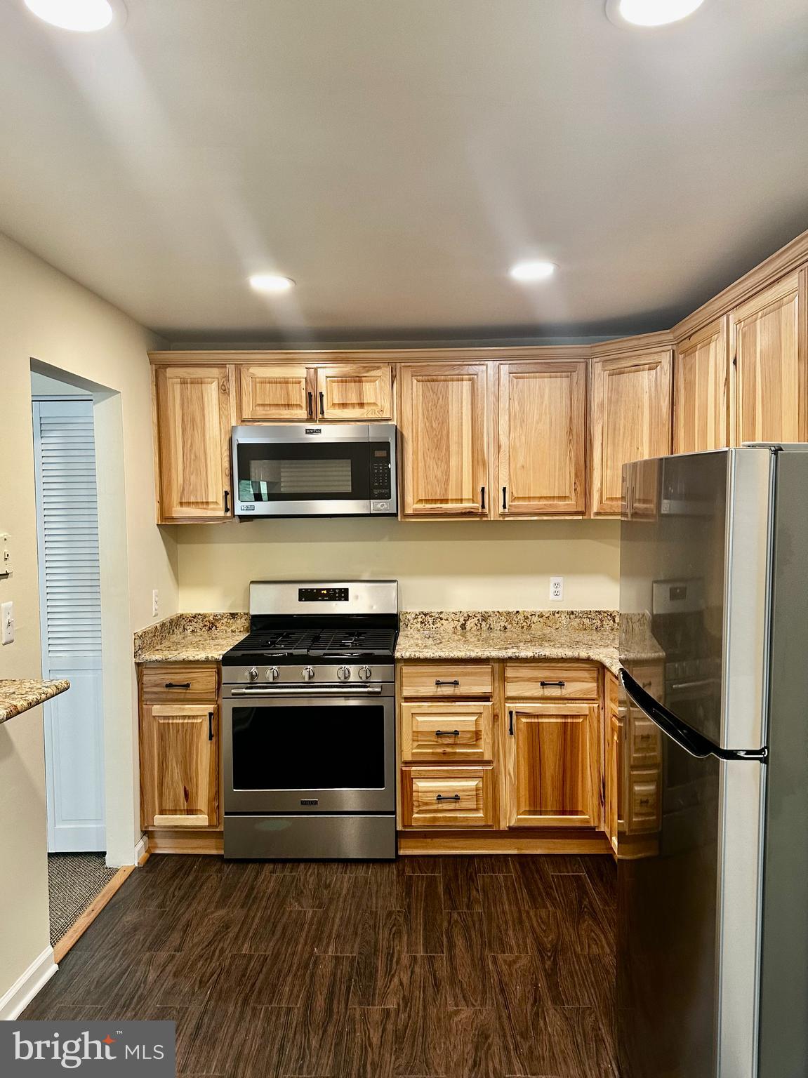 7904 Inverton Road, Unit 204 Annandale, VA 22003 - Photo 6 of 24 a kitchen with stainless steel appliances granite countertop a stove a refrigerator and a microwave