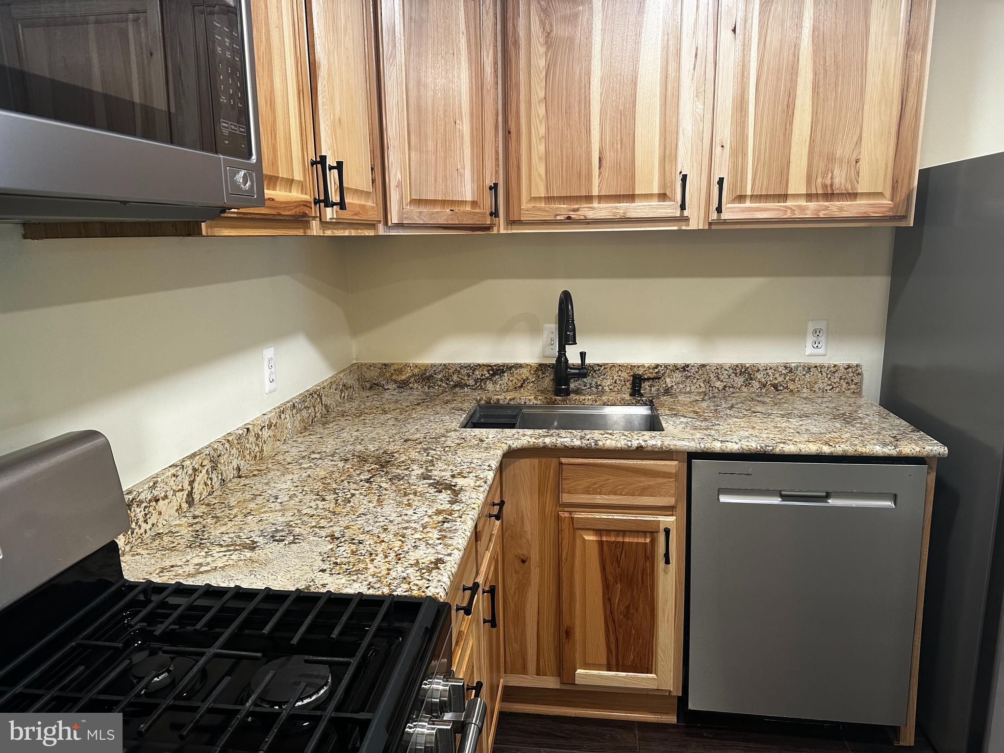 7904 Inverton Road, Unit 204 Annandale, VA 22003 - Photo 8 of 24 a kitchen with granite countertop a sink and a white cabinets
