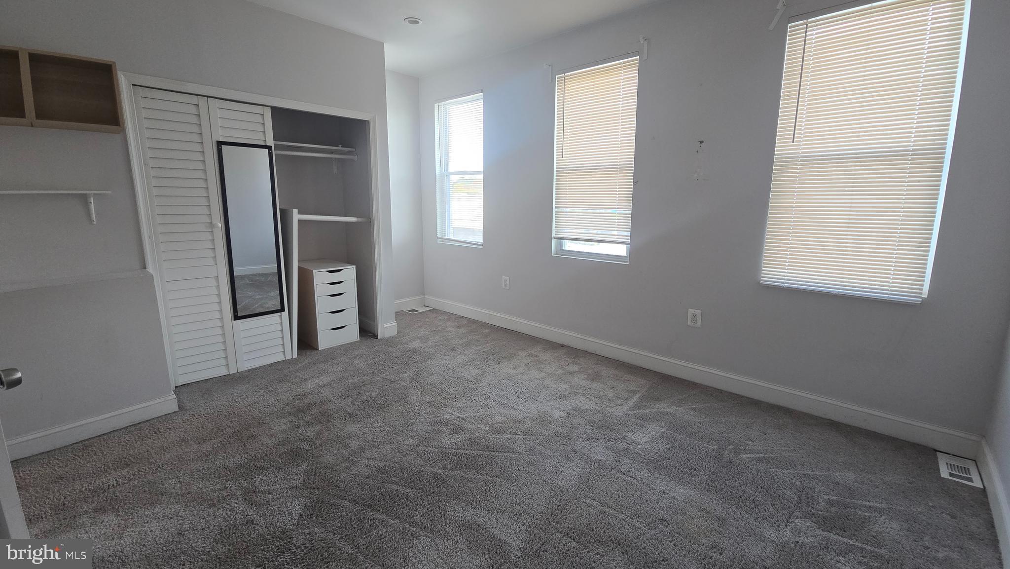 6814 Harford Road Baltimore, MD 21234 - Photo 12 of 27 an empty room with windows and closet