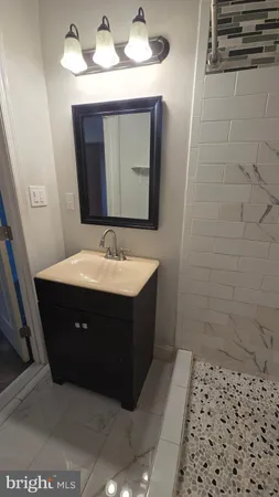 a bathroom with a sink vanity and mirror
